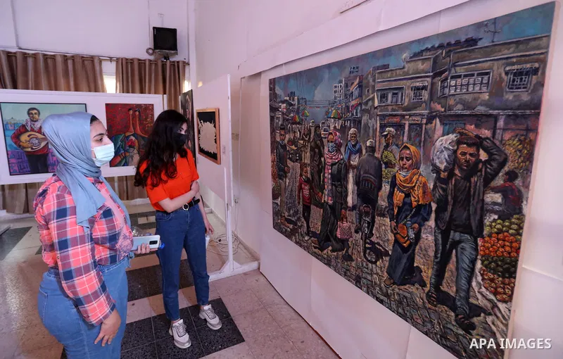 Palestinians attend an exhibition of paintings and sculptures, organized by the Gaza Center for Culture and Arts Association "The Third Gaza Contemporary Visual Arts Festival 2021" in Gaza City, on June 28, 2021. Photo b...