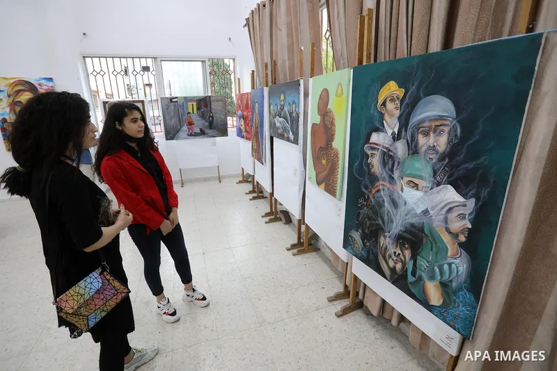 Palestinians attend an exhibition of paintings and sculptures, organized by the Gaza Center for Culture and Arts Association "The Third Gaza Contemporary Visual Arts Festival 2021" in Gaza City, on June 28, 2021. Photo b...
