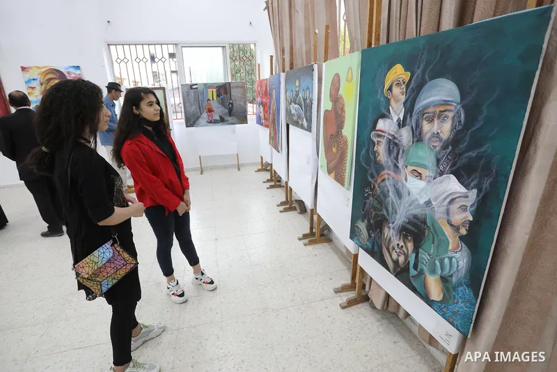 Palestinians attend an exhibition of paintings and sculptures, organized by the Gaza Center for Culture and Arts Association "The Third Gaza Contemporary Visual Arts Festival 2021" in Gaza City, on June 28, 2021. Photo b...
