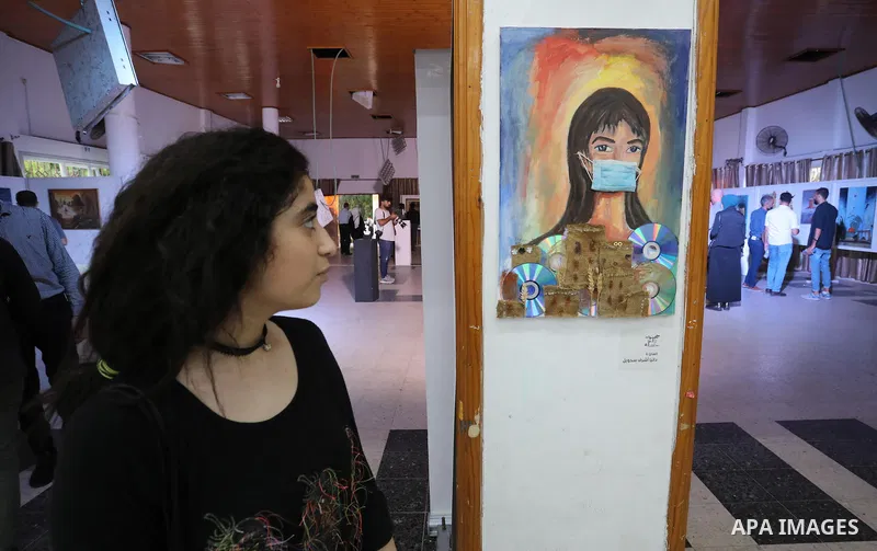 Palestinians attend an exhibition of paintings and sculptures, organized by the Gaza Center for Culture and Arts Association "The Third Gaza Contemporary Visual Arts Festival 2021" in Gaza City, on June 28, 2021. Photo b...