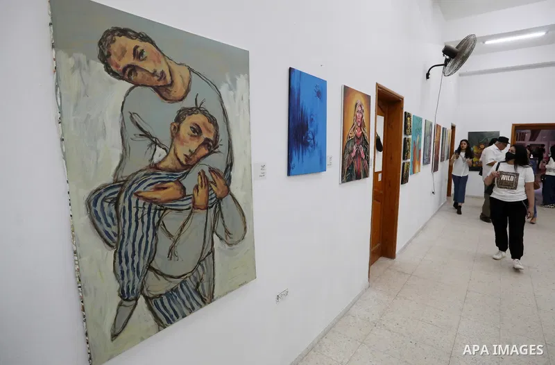 Palestinians attend an exhibition of paintings and sculptures, organized by the Gaza Center for Culture and Arts Association "The Third Gaza Contemporary Visual Arts Festival 2021" in Gaza City, on June 28, 2021. Photo b...