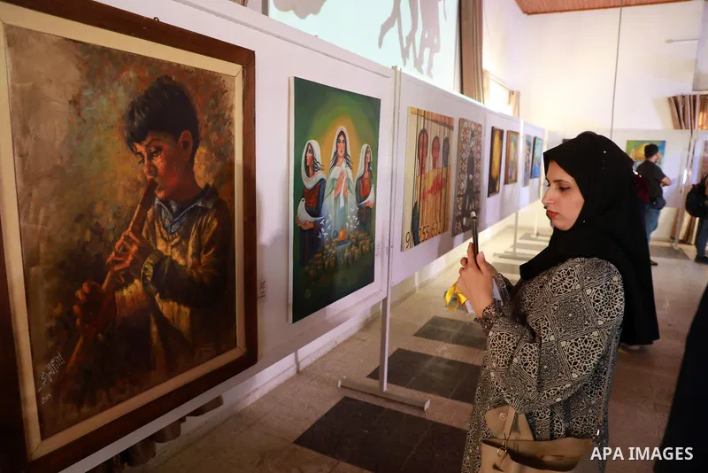 Palestinians attend an exhibition of paintings and sculptures, organized by the Gaza Center for Culture and Arts Association "The Third Gaza Contemporary Visual Arts Festival 2021" in Gaza City, on June 28, 2021. Photo b...