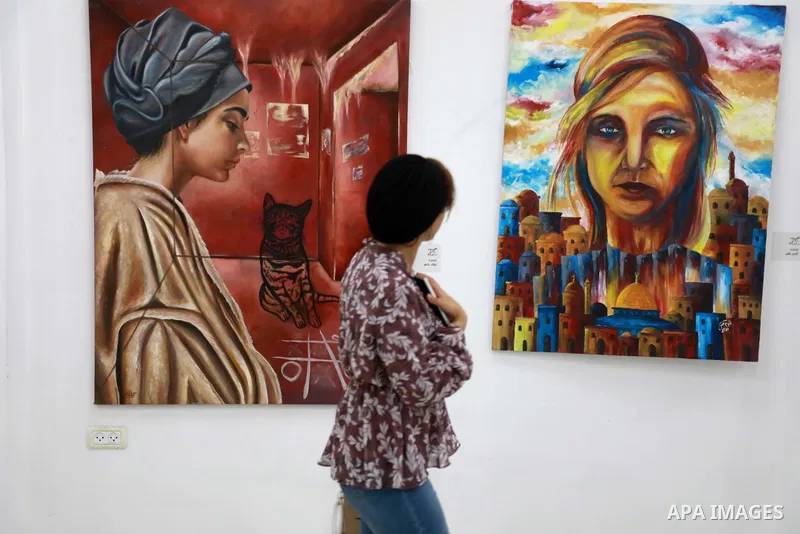 Palestinians attend an exhibition of paintings and sculptures, organized by the Gaza Center for Culture and Arts Association "The Third Gaza Contemporary Visual Arts Festival 2021" in Gaza City, on June 28, 2021. Photo b...