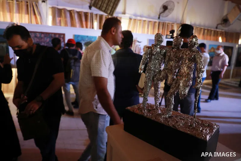 Palestinians attend an exhibition of paintings and sculptures, organized by the Gaza Center for Culture and Arts Association "The Third Gaza Contemporary Visual Arts Festival 2021" in Gaza City, on June 28, 2021. Photo b...