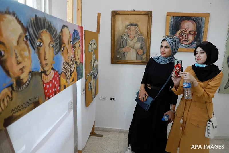 Palestinians attend an exhibition of paintings and sculptures, organized by the Gaza Center for Culture and Arts Association "The Third Gaza Contemporary Visual Arts Festival 2021" in Gaza City, on June 28, 2021. Photo b...