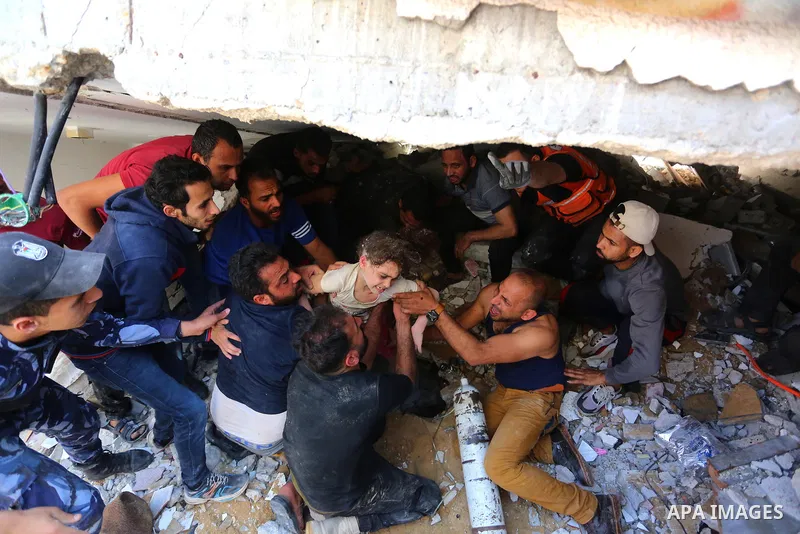Palestinians search for victims under the rubble of a destroyed building in Gaza City's Rimal residential district following massive Israeli bombardment on the Hamas-controlled enclave on May 16, 2021. Deadly violence er...