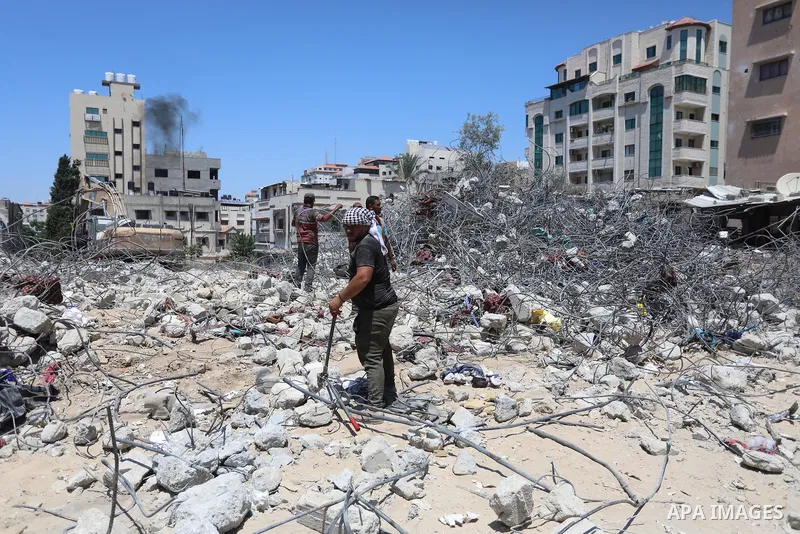 Palestinian engineer Ahmed Al-Qiq, 30, inspects damage at his center for the Training and Development, which was destroyed by Israeli air strikes during the May 2021 conflict between Hamas and Israel, in Gaza city, on Ju...
