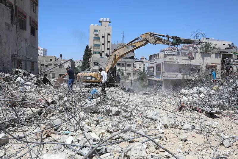Palestinian engineer Ahmed Al-Qiq, 30, inspects damage at his center for the Training and Development, which was destroyed by Israeli air strikes during the May 2021 conflict between Hamas and Israel, in Gaza city, on Ju...
