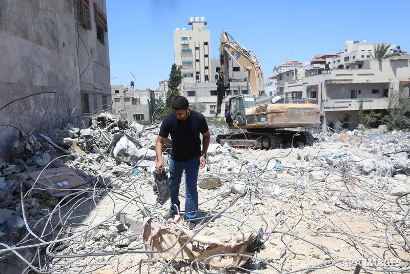 Palestinian engineer Ahmed Al-Qiq, 30, inspects damage at his center for the Training and Development, which was destroyed by Israeli air strikes during the May 2021 conflict between Hamas and Israel, in Gaza city, on Ju...