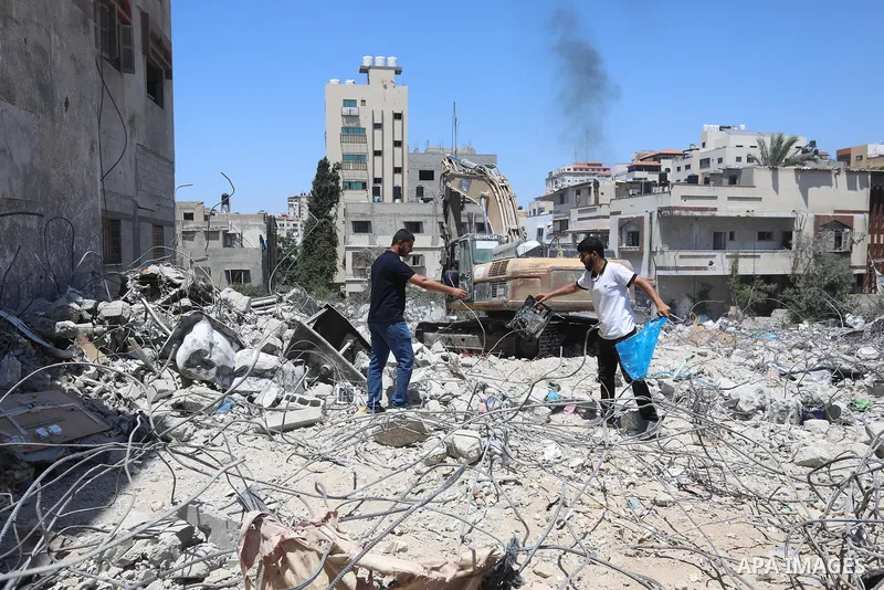 Palestinian engineer Ahmed Al-Qiq, 30, inspects damage at his center for the Training and Development, which was destroyed by Israeli air strikes during the May 2021 conflict between Hamas and Israel, in Gaza city, on Ju...