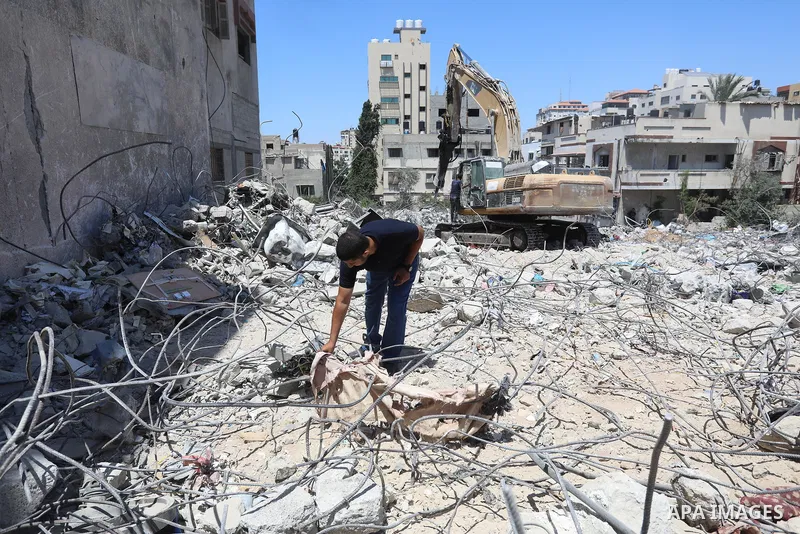 Palestinian engineer Ahmed Al-Qiq, 30, inspects damage at his center for the Training and Development, which was destroyed by Israeli air strikes during the May 2021 conflict between Hamas and Israel, in Gaza city, on Ju...