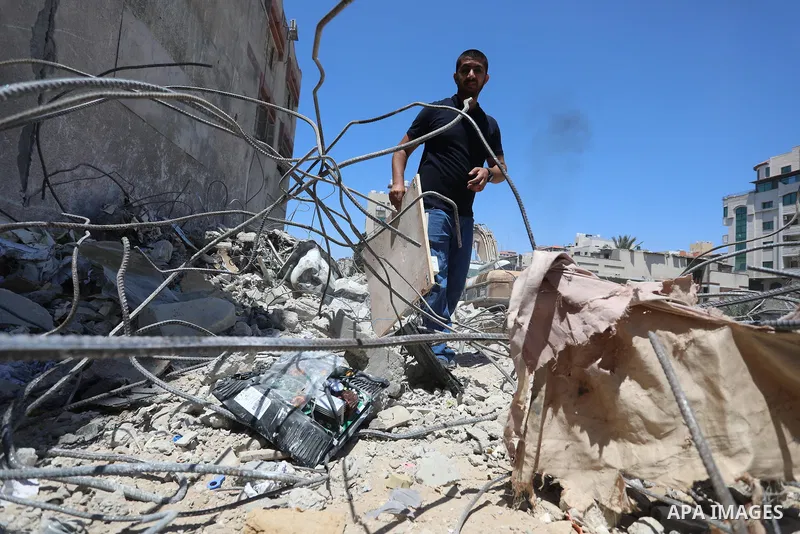 Palestinian engineer Ahmed Al-Qiq, 30, inspects damage at his center for the Training and Development, which was destroyed by Israeli air strikes during the May 2021 conflict between Hamas and Israel, in Gaza city, on Ju...
