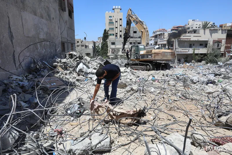 Palestinian engineer Ahmed Al-Qiq, 30, inspects damage at his center for the Training and Development, which was destroyed by Israeli air strikes during the May 2021 conflict between Hamas and Israel, in Gaza city, on Ju...