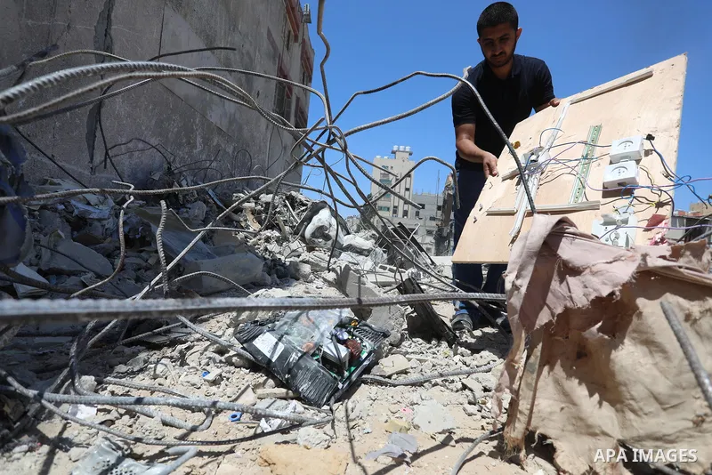 Palestinian engineer Ahmed Al-Qiq, 30, inspects damage at his center for the Training and Development, which was destroyed by Israeli air strikes during the May 2021 conflict between Hamas and Israel, in Gaza city, on Ju...