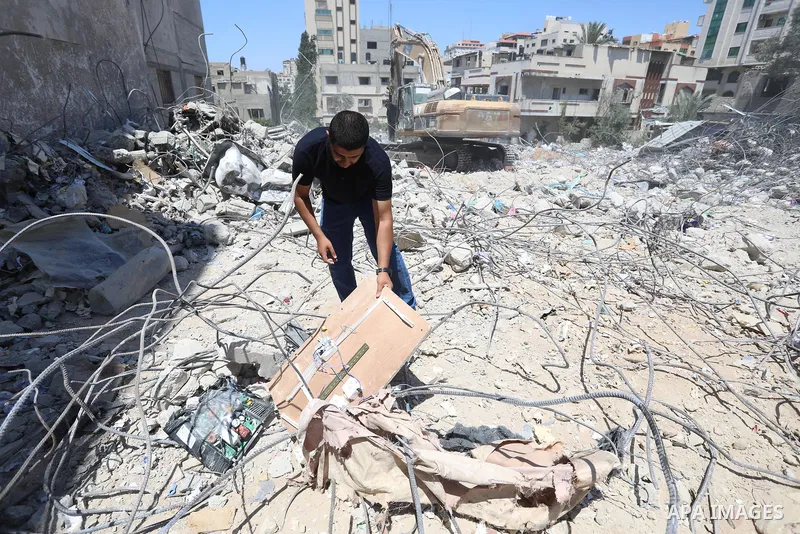 Palestinian engineer Ahmed Al-Qiq, 30, inspects damage at his center for the Training and Development, which was destroyed by Israeli air strikes during the May 2021 conflict between Hamas and Israel, in Gaza city, on Ju...