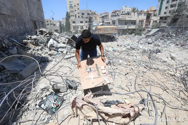 Palestinian engineer Ahmed Al-Qiq, 30, inspects damage at his center for the Training and Development, which was destroyed by Israeli air strikes during the May 2021 conflict between Hamas and Israel, in Gaza city, on Ju...