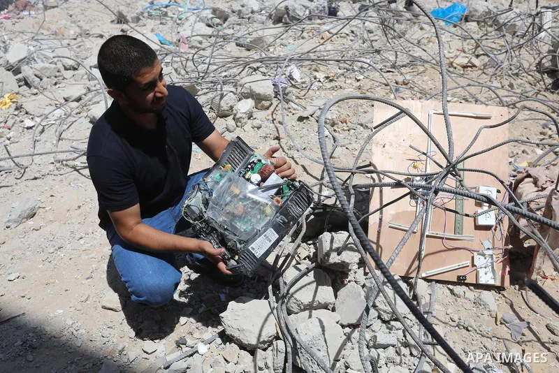 Palestinian engineer Ahmed Al-Qiq, 30, inspects damage at his center for the Training and Development, which was destroyed by Israeli air strikes during the May 2021 conflict between Hamas and Israel, in Gaza city, on Ju...