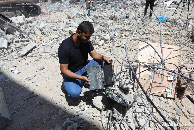 Palestinian engineer Ahmed Al-Qiq, 30, inspects damage at his center for the Training and Development, which was destroyed by Israeli air strikes during the May 2021 conflict between Hamas and Israel, in Gaza city, on Ju...