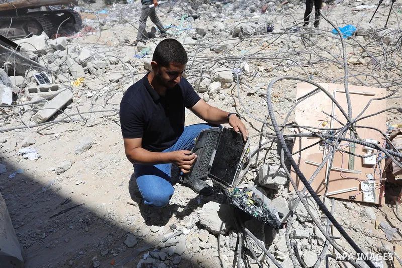 Palestinian engineer Ahmed Al-Qiq, 30, inspects damage at his center for the Training and Development, which was destroyed by Israeli air strikes during the May 2021 conflict between Hamas and Israel, in Gaza city, on Ju...