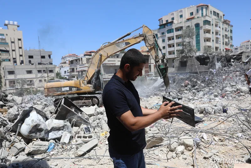 Palestinian engineer Ahmed Al-Qiq, 30, inspects damage at his center for the Training and Development, which was destroyed by Israeli air strikes during the May 2021 conflict between Hamas and Israel, in Gaza city, on Ju...