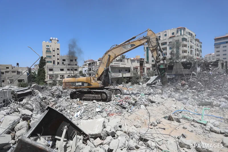 Palestinian engineer Ahmed Al-Qiq, 30, inspects damage at his center for the Training and Development, which was destroyed by Israeli air strikes during the May 2021 conflict between Hamas and Israel, in Gaza city, on Ju...