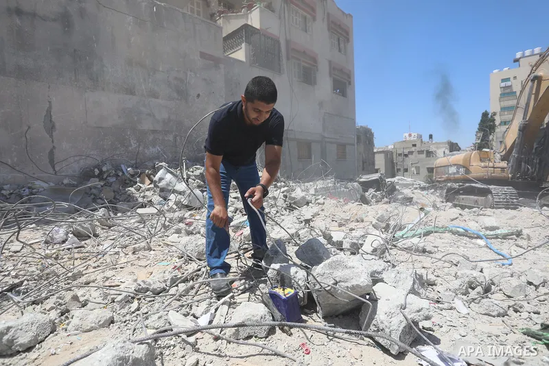 Palestinian engineer Ahmed Al-Qiq, 30, inspects damage at his center for the Training and Development, which was destroyed by Israeli air strikes during the May 2021 conflict between Hamas and Israel, in Gaza city, on Ju...