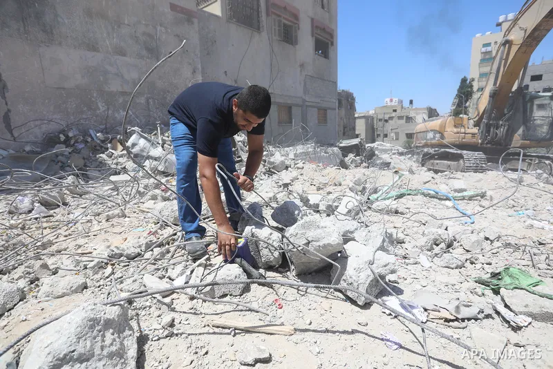 Palestinian engineer Ahmed Al-Qiq, 30, inspects damage at his center for the Training and Development, which was destroyed by Israeli air strikes during the May 2021 conflict between Hamas and Israel, in Gaza city, on Ju...