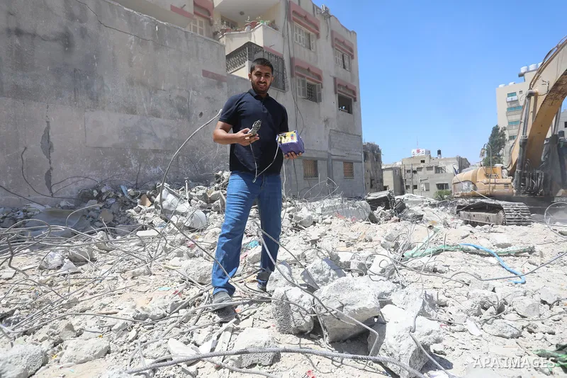 Palestinian engineer Ahmed Al-Qiq, 30, inspects damage at his center for the Training and Development, which was destroyed by Israeli air strikes during the May 2021 conflict between Hamas and Israel, in Gaza city, on Ju...
