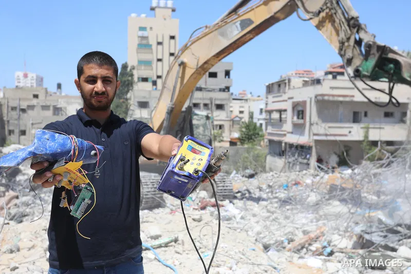 Palestinian engineer Ahmed Al-Qiq, 30, inspects damage at his center for the Training and Development, which was destroyed by Israeli air strikes during the May 2021 conflict between Hamas and Israel, in Gaza city, on Ju...