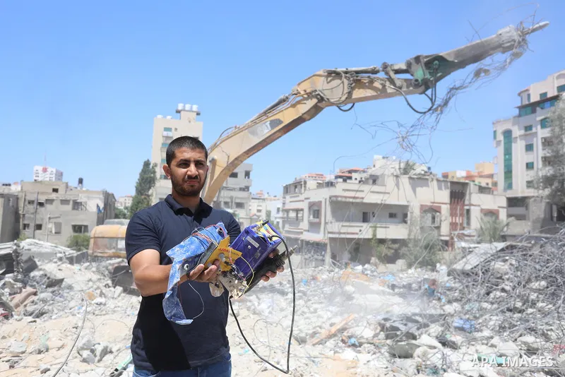 Palestinian engineer Ahmed Al-Qiq, 30, inspects damage at his center for the Training and Development, which was destroyed by Israeli air strikes during the May 2021 conflict between Hamas and Israel, in Gaza city, on Ju...