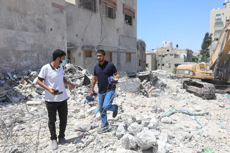 Palestinian engineer Ahmed Al-Qiq, 30, inspects damage at his center for the Training and Development, which was destroyed by Israeli air strikes during the May 2021 conflict between Hamas and Israel, in Gaza city, on Ju...