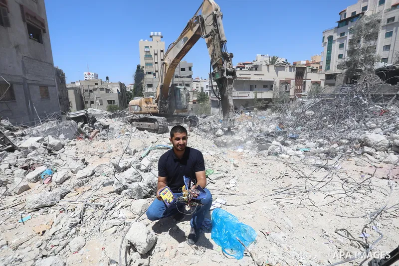 Palestinian engineer Ahmed Al-Qiq, 30, inspects damage at his center for the Training and Development, which was destroyed by Israeli air strikes during the May 2021 conflict between Hamas and Israel, in Gaza city, on Ju...