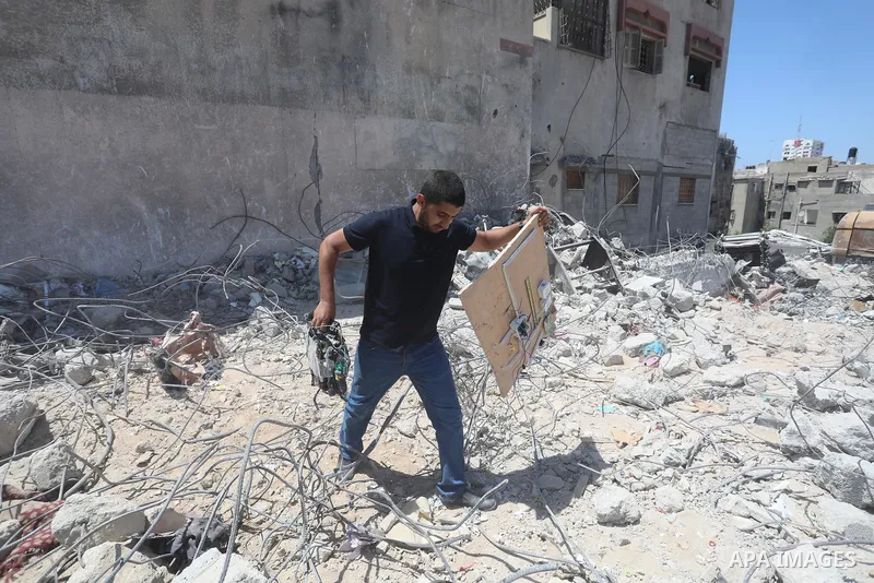 Palestinian engineer Ahmed Al-Qiq, 30, inspects damage at his center for the Training and Development, which was destroyed by Israeli air strikes during the May 2021 conflict between Hamas and Israel, in Gaza city, on Ju...