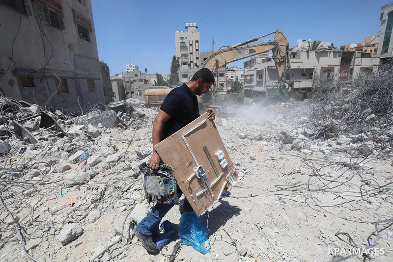 Palestinian engineer Ahmed Al-Qiq, 30, inspects damage at his center for the Training and Development, which was destroyed by Israeli air strikes during the May 2021 conflict between Hamas and Israel, in Gaza city, on Ju...