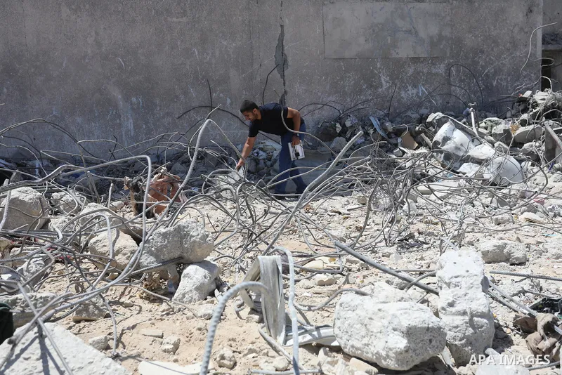Palestinian engineer Ahmed Al-Qiq, 30, inspects damage at his center for the Training and Development, which was destroyed by Israeli air strikes during the May 2021 conflict between Hamas and Israel, in Gaza city, on Ju...