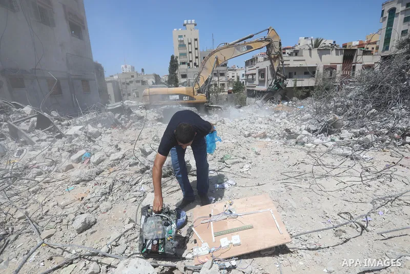Palestinian engineer Ahmed Al-Qiq, 30, inspects damage at his center for the Training and Development, which was destroyed by Israeli air strikes during the May 2021 conflict between Hamas and Israel, in Gaza city, on Ju...