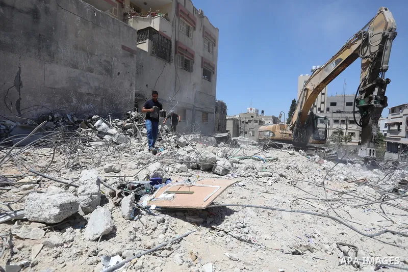 Palestinian engineer Ahmed Al-Qiq, 30, inspects damage at his center for the Training and Development, which was destroyed by Israeli air strikes during the May 2021 conflict between Hamas and Israel, in Gaza city, on Ju...