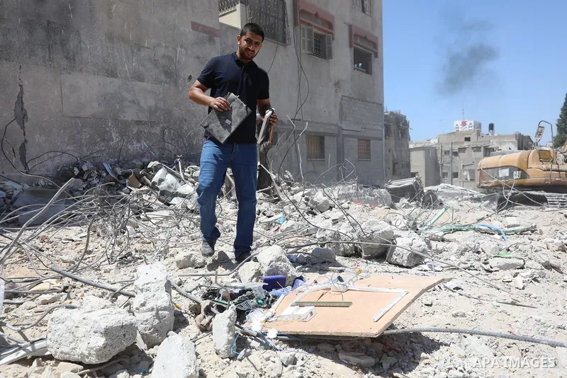 Palestinian engineer Ahmed Al-Qiq, 30, inspects damage at his center for the Training and Development, which was destroyed by Israeli air strikes during the May 2021 conflict between Hamas and Israel, in Gaza city, on Ju...