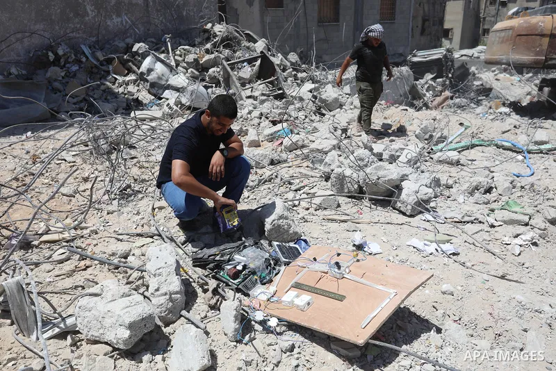 Palestinian engineer Ahmed Al-Qiq, 30, inspects damage at his center for the Training and Development, which was destroyed by Israeli air strikes during the May 2021 conflict between Hamas and Israel, in Gaza city, on Ju...