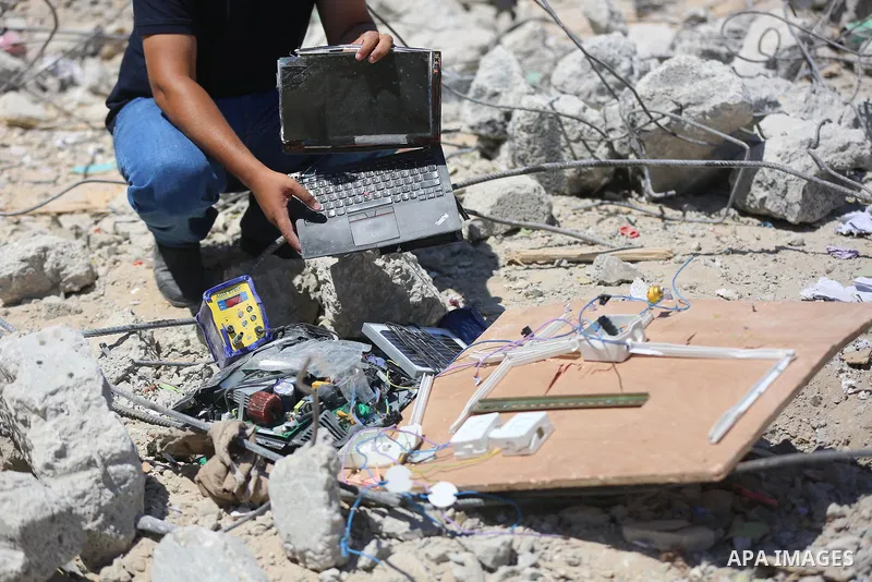 Palestinian engineer Ahmed Al-Qiq, 30, inspects damage at his center for the Training and Development, which was destroyed by Israeli air strikes during the May 2021 conflict between Hamas and Israel, in Gaza city, on Ju...