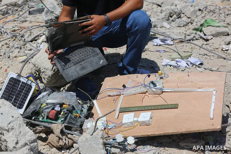 Palestinian engineer Ahmed Al-Qiq, 30, inspects damage at his center for the Training and Development, which was destroyed by Israeli air strikes during the May 2021 conflict between Hamas and Israel, in Gaza city, on Ju...