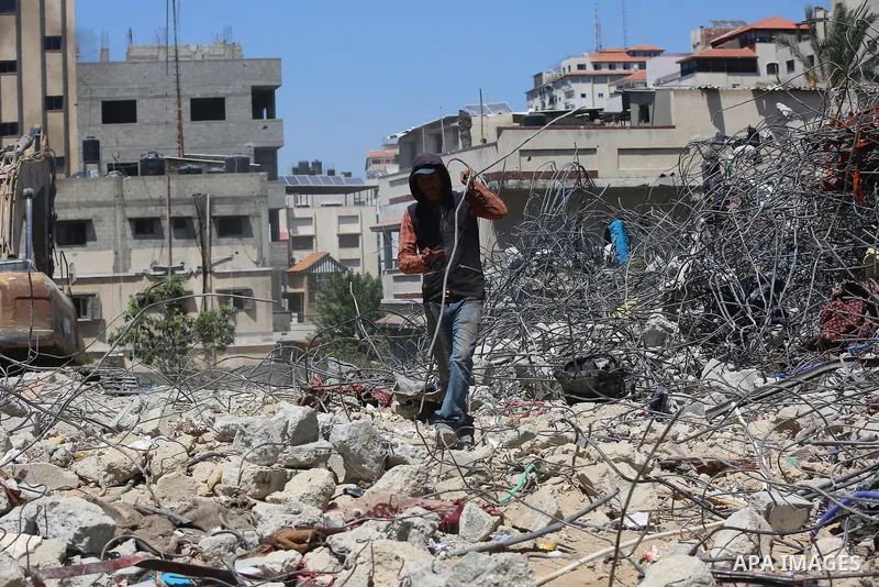 Palestinian engineer Ahmed Al-Qiq, 30, inspects damage at his center for the Training and Development, which was destroyed by Israeli air strikes during the May 2021 conflict between Hamas and Israel, in Gaza city, on Ju...