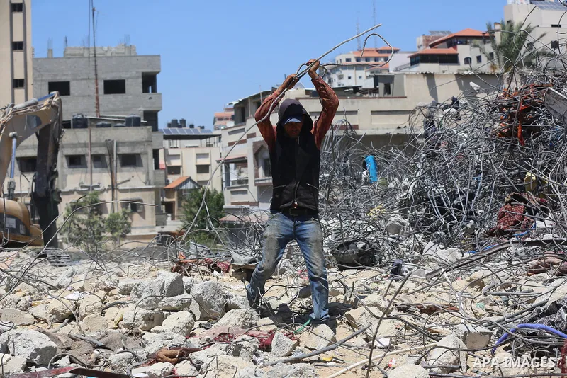 Palestinian engineer Ahmed Al-Qiq, 30, inspects damage at his center for the Training and Development, which was destroyed by Israeli air strikes during the May 2021 conflict between Hamas and Israel, in Gaza city, on Ju...