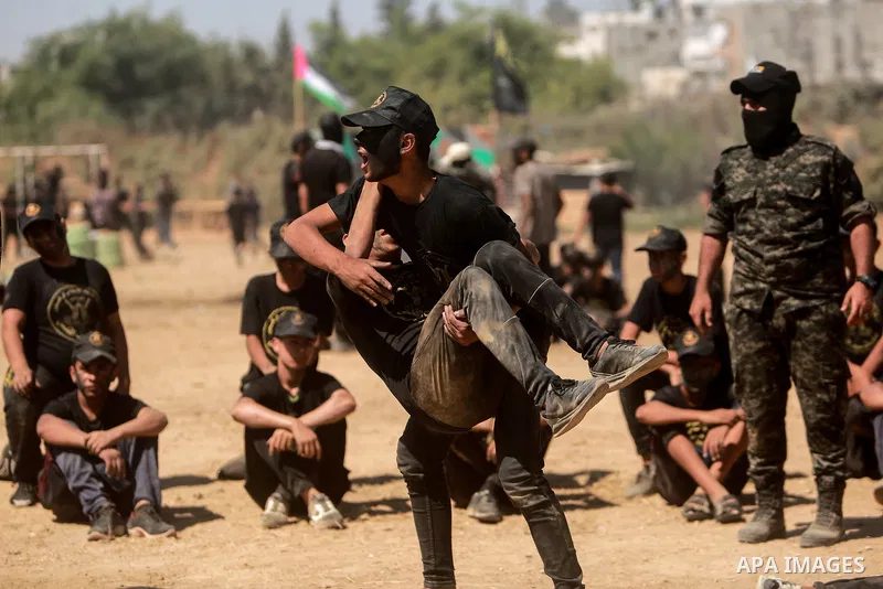 Young Palestinians attend a military summer camp organised by the Islamic Jihad Movement, in Gaza City, June 29, 2021. Photo by Mohammed Dahman Young Palestinians attend a military summer camp organised by the Islamic Ji...