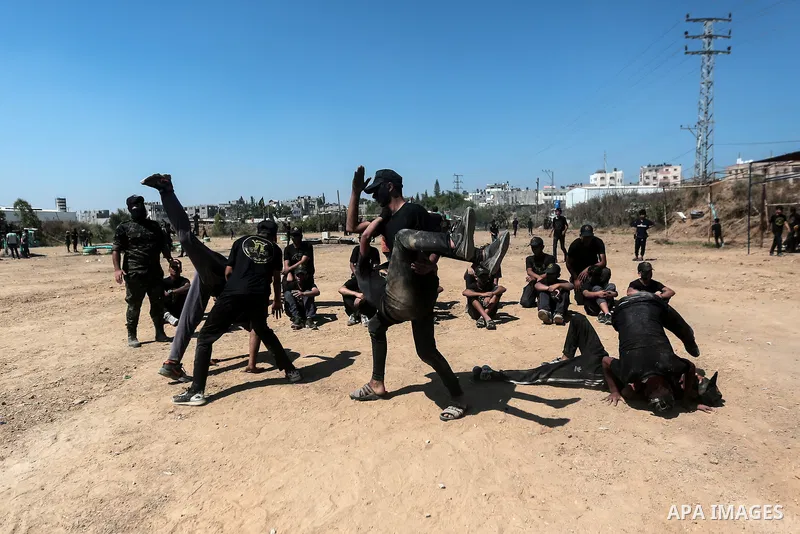 Young Palestinians attend a military summer camp organised by the Islamic Jihad Movement, in Gaza City, June 29, 2021. Photo by Mohammed Dahman Young Palestinians attend a military summer camp organised by the Islamic Ji...