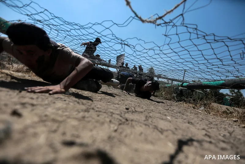 Young Palestinians attend a military summer camp organised by the Islamic Jihad Movement, in Gaza City, June 29, 2021. Photo by Mohammed Dahman Young Palestinians attend a military summer camp organised by the Islamic Ji...