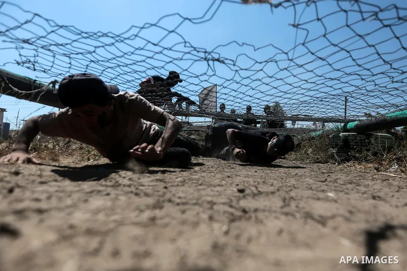 Young Palestinians attend a military summer camp organised by the Islamic Jihad Movement, in Gaza City, June 29, 2021. Photo by Mohammed Dahman Young Palestinians attend a military summer camp organised by the Islamic Ji...