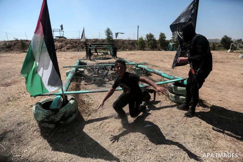 Young Palestinians attend a military summer camp organised by the Islamic Jihad Movement, in Gaza City, June 29, 2021. Photo by Mohammed Dahman Young Palestinians attend a military summer camp organised by the Islamic Ji...