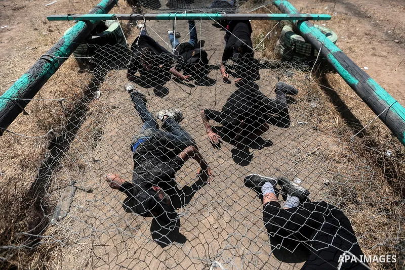 Young Palestinians attend a military summer camp organised by the Islamic Jihad Movement, in Gaza City, June 29, 2021. Photo by Mohammed Dahman Young Palestinians attend a military summer camp organised by the Islamic Ji...