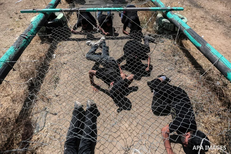 Young Palestinians attend a military summer camp organised by the Islamic Jihad Movement, in Gaza City, June 29, 2021. Photo by Mohammed Dahman Young Palestinians attend a military summer camp organised by the Islamic Ji...